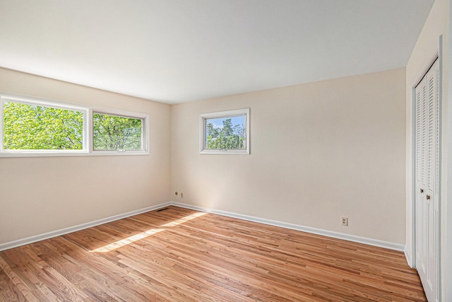 2038 S 7th St, Ann Arbor, MI 48103 - unfurnished bedroom with baseboards, light wood finished floors, and a closet