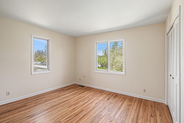 2038 S 7th St, Ann Arbor, MI 48103 - unfurnished bedroom featuring baseboards, a closet, light wood-style flooring, and visible vents