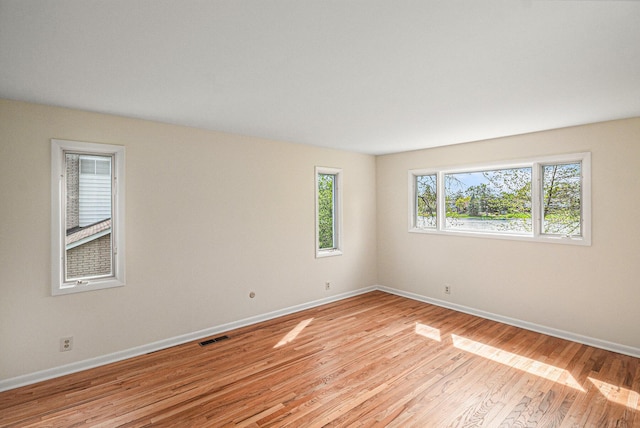 2038 S 7th St, Ann Arbor, MI 48103 - empty room with baseboards, light wood-type flooring, and visible vents