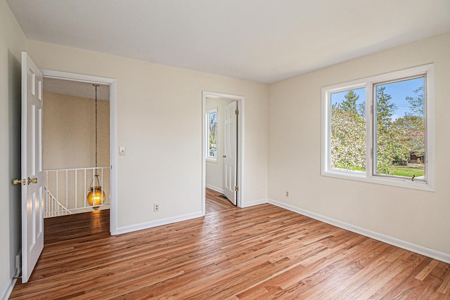 2038 S 7th St, Ann Arbor, MI 48103 - unfurnished bedroom featuring baseboards and wood finished floors