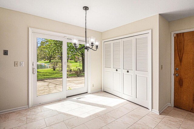 2038 S 7th St, Ann Arbor, MI 48103 - unfurnished dining area with baseboards, a notable chandelier, and visible vents