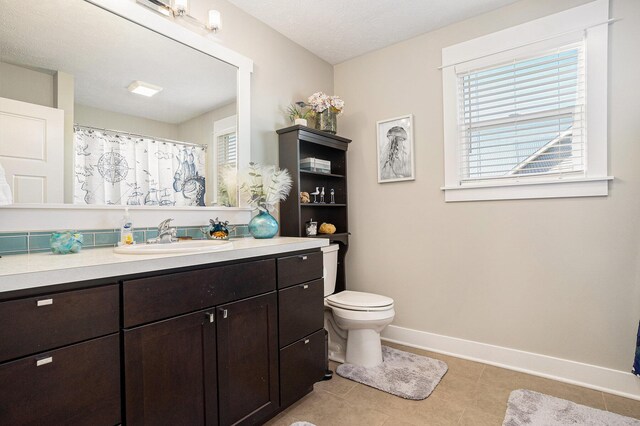 3080 Silver Fir Ct, Holland, MI 49424 - bathroom featuring baseboards, tile patterned floors, vanity, toilet, and a shower with curtain