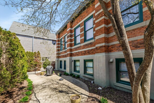 223 E Ann St Unit 1, Ann Arbor, MI 48104 - back of property featuring brick siding and fence