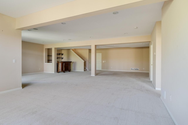 8660 Oakland Hills Cir, Portage, MI 49024 - finished basement featuring stairs, baseboards, light colored carpet, and visible vents