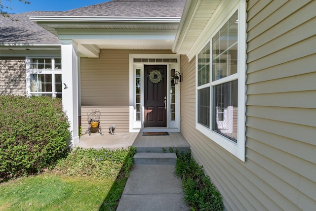 8660 Oakland Hills Cir, Portage, MI 49024 - view of exterior entry with a porch and roof with shingles