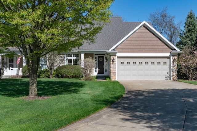 8660 Oakland Hills Cir, Portage, MI 49024 - view of front of house featuring an attached garage, concrete driveway, a front lawn, and stone siding
