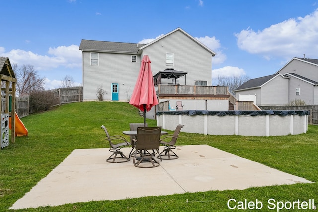 view of patio featuring a fenced backyard, a fenced in pool, and a gazebo