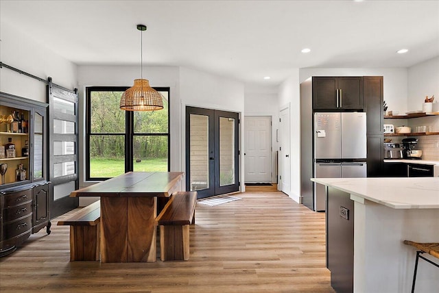 12950 Flynn Rd, Sawyer, MI 49125 - kitchen featuring freestanding refrigerator, light wood-type flooring, decorative light fixtures, french doors, and recessed lighting