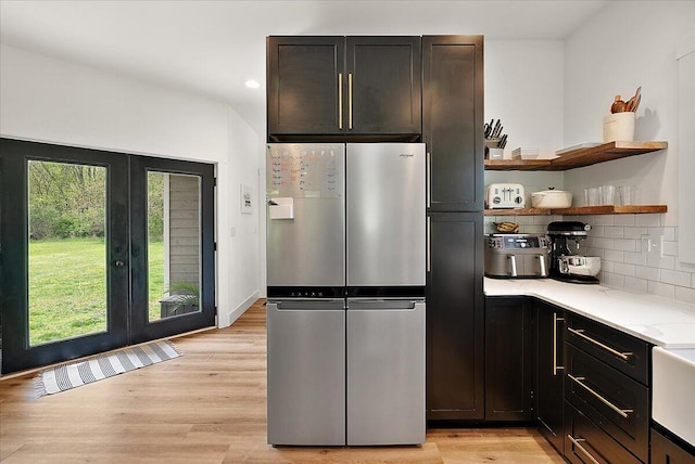 12950 Flynn Rd, Sawyer, MI 49125 - kitchen featuring freestanding refrigerator, light countertops, open shelves, light wood-type flooring, and french doors