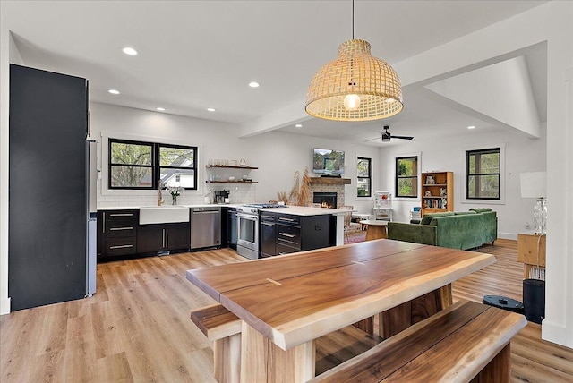 12950 Flynn Rd, Sawyer, MI 49125 - dining space featuring recessed lighting, a stone fireplace, ceiling fan, plenty of natural light, and light wood-style floors