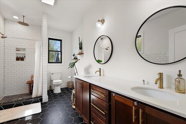 12950 Flynn Rd, Sawyer, MI 49125 - bathroom with double vanity, a tile shower, toilet, and tile patterned flooring