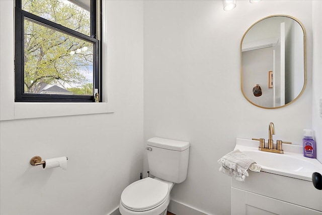 12950 Flynn Rd, Sawyer, MI 49125 - bathroom with toilet, healthy amount of natural light, baseboards, and vanity