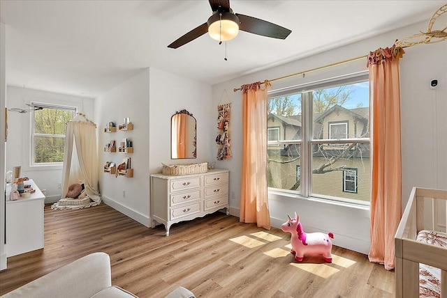 12950 Flynn Rd, Sawyer, MI 49125 - bedroom featuring light wood-type flooring, baseboards, and a ceiling fan