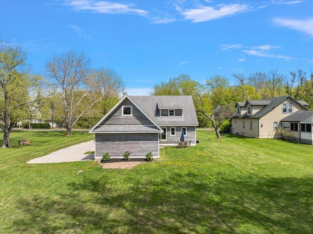 12950 Flynn Rd, Sawyer, MI 49125 - rear view of property featuring a lawn and a shingled roof