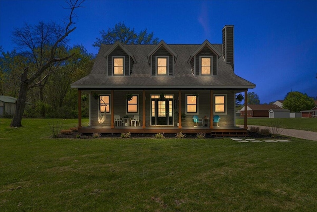 12950 Flynn Rd, Sawyer, MI 49125 - view of front of home with a porch, a chimney, and a lawn
