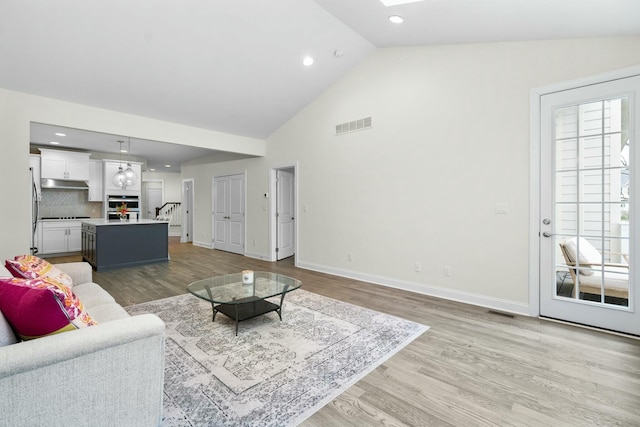 3100 Millbury Ln, Ann Arbor, MI 48105 - living area with stairs, light wood-type flooring, high vaulted ceiling, recessed lighting, and a skylight