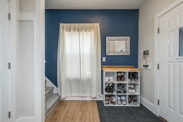1146 Hall St SE, Grand Rapids, MI 49507 - entrance foyer featuring baseboards, wood finished floors, and stairway