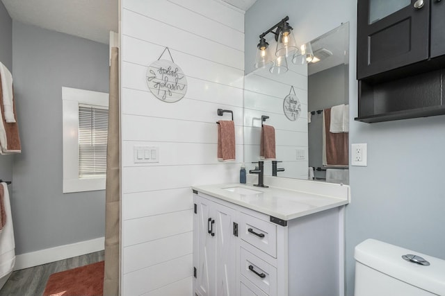 1146 Hall St SE, Grand Rapids, MI 49507 - bathroom featuring vanity, baseboards, toilet, and wood finished floors