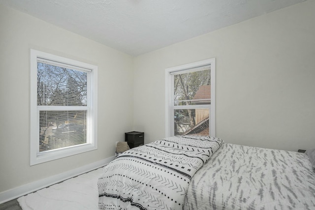 1146 Hall St SE, Grand Rapids, MI 49507 - bedroom featuring baseboards and multiple windows