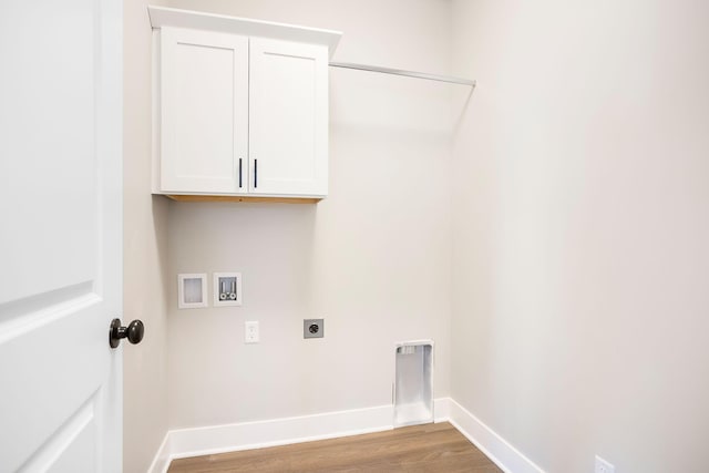 laundry area featuring electric dryer hookup, cabinet space, wood finished floors, baseboards, and hookup for a washing machine