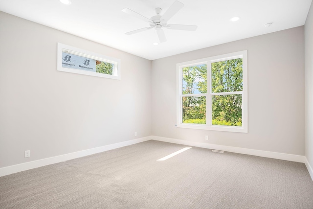 unfurnished room with a healthy amount of sunlight, baseboards, and carpet flooring