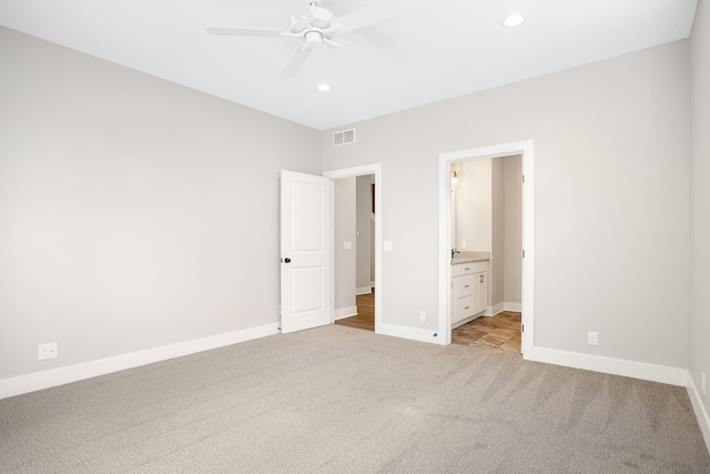unfurnished bedroom with light carpet, ensuite bath, recessed lighting, baseboards, and visible vents