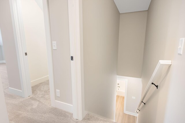 stairs with carpet floors and baseboards
