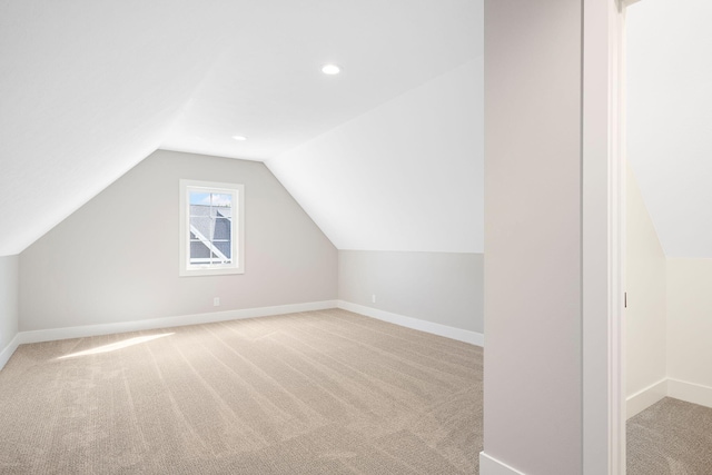 bonus room featuring carpet flooring, baseboards, and vaulted ceiling