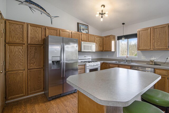 1077 Sun Valley Ln, Allegan, MI 49010 - kitchen featuring stainless steel appliances, brown cabinetry, and a sink