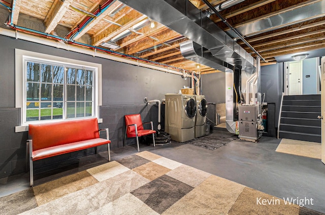 below grade area featuring independent washer and dryer, heating unit, and stairs