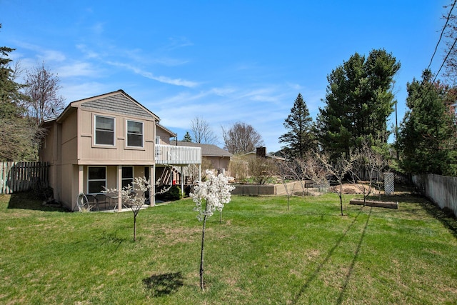 17653 Hiawatha Dr, Spring Lake, MI 49456 - back of house featuring a patio, a deck, and a vegetable garden