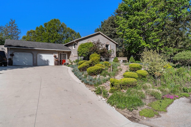 17653 Hiawatha Dr, Spring Lake, MI 49456 - tri-level home with an attached garage and driveway