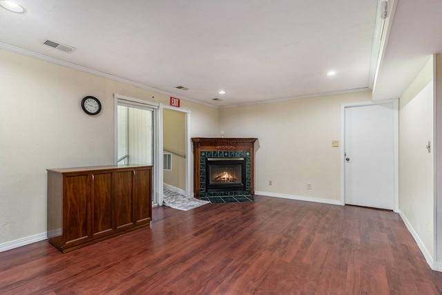 17653 Hiawatha Dr, Spring Lake, MI 49456 - unfurnished living room featuring dark wood-style flooring, crown molding, a fireplace, recessed lighting, and baseboards
