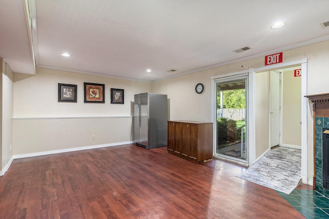 17653 Hiawatha Dr, Spring Lake, MI 49456 - unfurnished living room featuring crown molding, a tile fireplace, dark wood-type flooring, baseboards, and recessed lighting