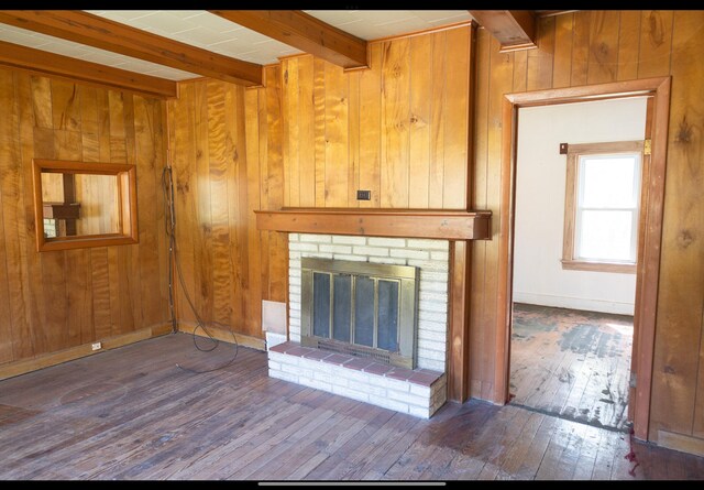 15232 Three Oaks Rd, Three Oaks, MI 49128 - unfurnished living room with wooden walls, a fireplace, beam ceiling, and hardwood / wood-style floors