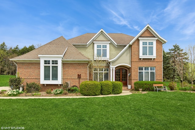 2235 Winters Way, Saint Joseph, MI 49085 - craftsman house featuring brick siding, roof with shingles, and a front yard