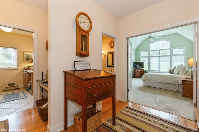 2235 Winters Way, Saint Joseph, MI 49085 - hallway with light wood-style floors, a wealth of natural light, vaulted ceiling, and visible vents