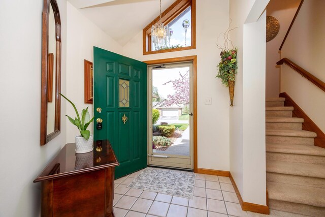 3108 N Rivers Edge Dr, Wayne, MI 48184 - entryway featuring baseboards, light tile patterned floors, vaulted ceiling, and stairway