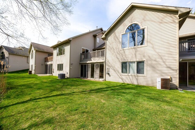3108 N Rivers Edge Dr, Wayne, MI 48184 - rear view of house with a lawn, central air condition unit, and a balcony