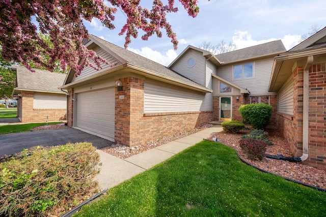 3108 N Rivers Edge Dr, Wayne, MI 48184 - traditional home featuring a garage, a shingled roof, driveway, and brick siding