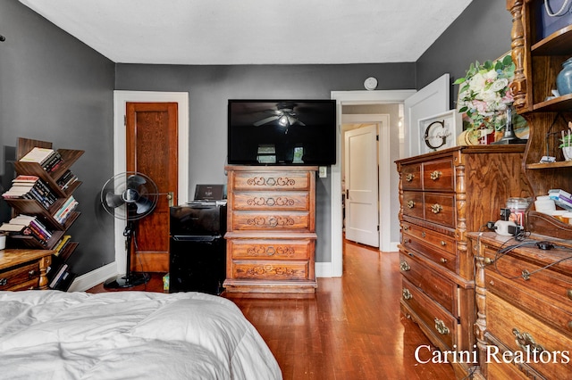 bedroom featuring baseboards and wood finished floors