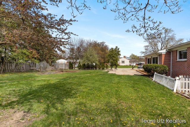 view of yard with a fenced backyard and a patio
