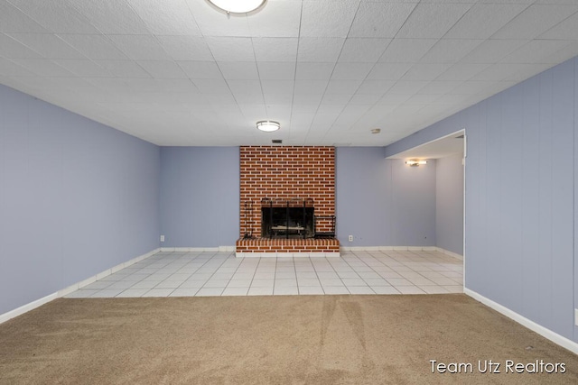 unfurnished living room featuring carpet floors, tile patterned flooring, and a fireplace
