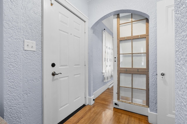 1021 Roseland Ave, Kalamazoo, MI 49001 - entrance foyer featuring a textured wall, arched walkways, and wood finished floors