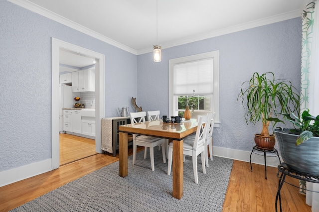 1021 Roseland Ave, Kalamazoo, MI 49001 - dining space featuring a textured wall, light wood finished floors, ornamental molding, and beverage cooler