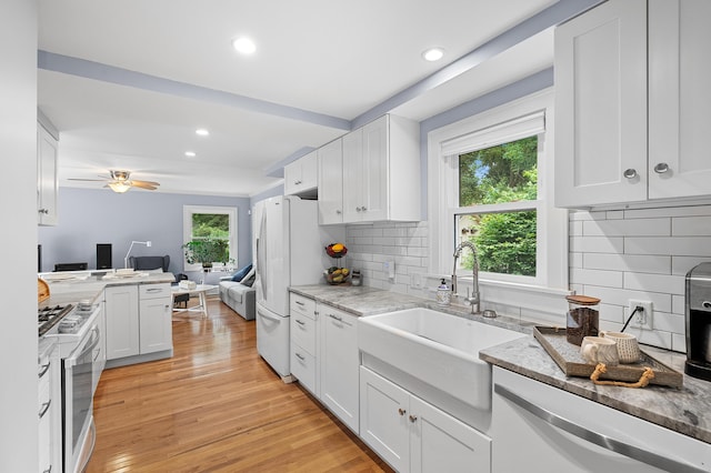 1021 Roseland Ave, Kalamazoo, MI 49001 - kitchen featuring white appliances, open floor plan, healthy amount of natural light, white cabinets, and recessed lighting