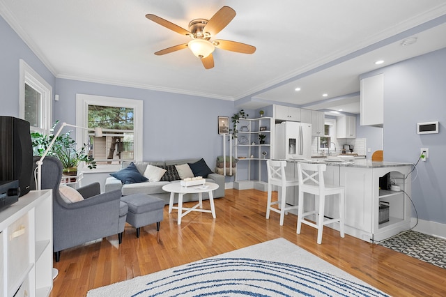 1021 Roseland Ave, Kalamazoo, MI 49001 - living room featuring light wood finished floors, ceiling fan, ornamental molding, and recessed lighting