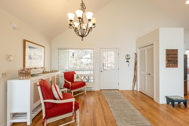 14 N Lighthouse Dr, Mears, MI 49436 - entrance foyer featuring an inviting chandelier, lofted ceiling, and light wood-type flooring