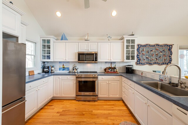 14 N Lighthouse Dr, Mears, MI 49436 - kitchen featuring plenty of natural light, a sink, appliances with stainless steel finishes, and backsplash