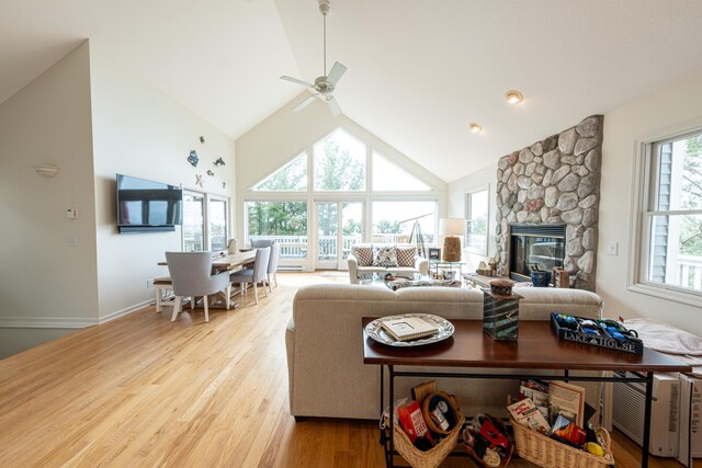 14 N Lighthouse Dr, Mears, MI 49436 - living area featuring light wood-style flooring, ceiling fan, high vaulted ceiling, and a fireplace